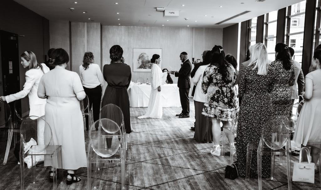 Intimate wedding ceremony setup with clear acrylic chairs at Hilton London Tower Bridge.