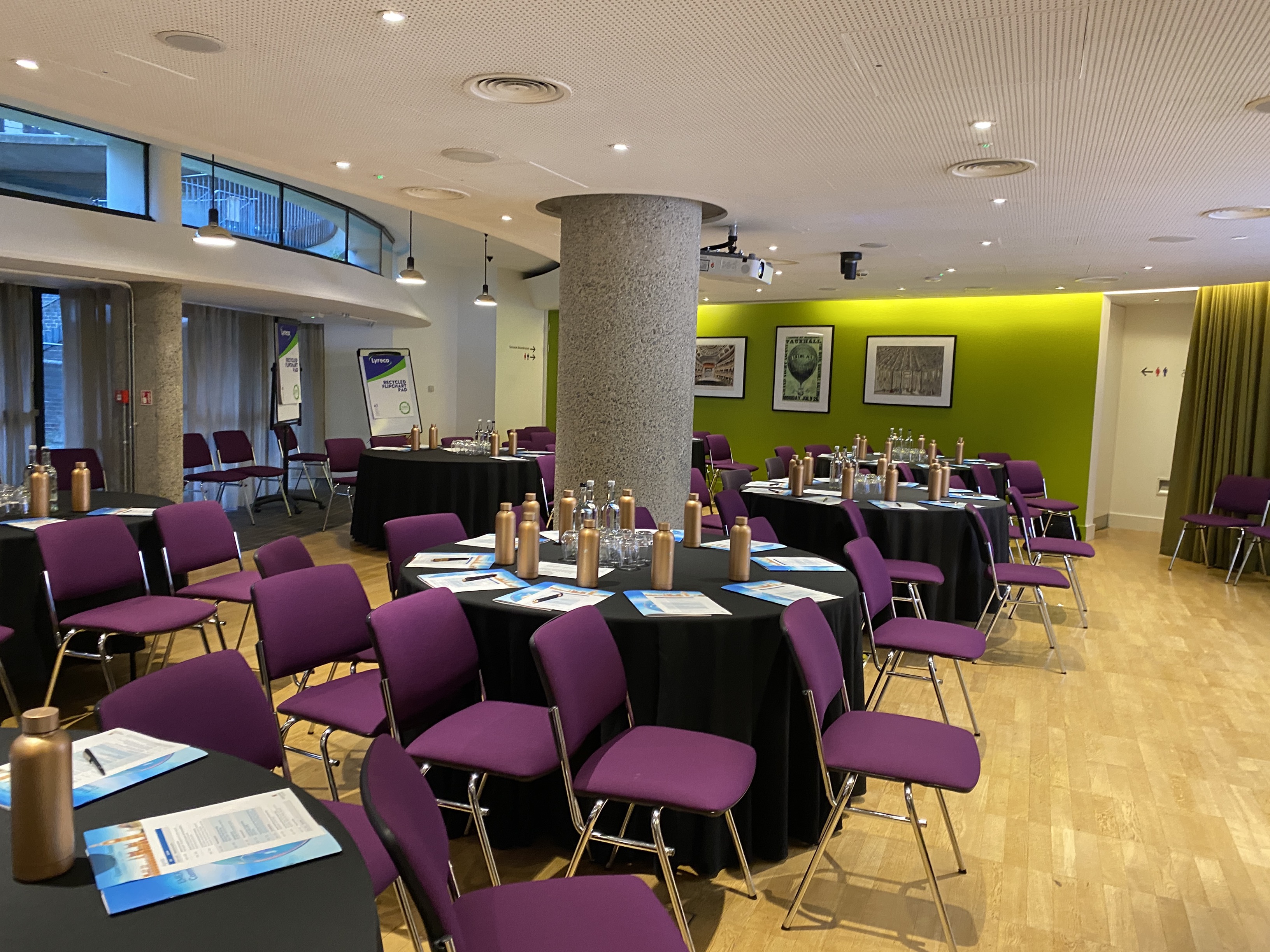 Terrace Gallery meeting space in London with round tables and purple chairs for events.