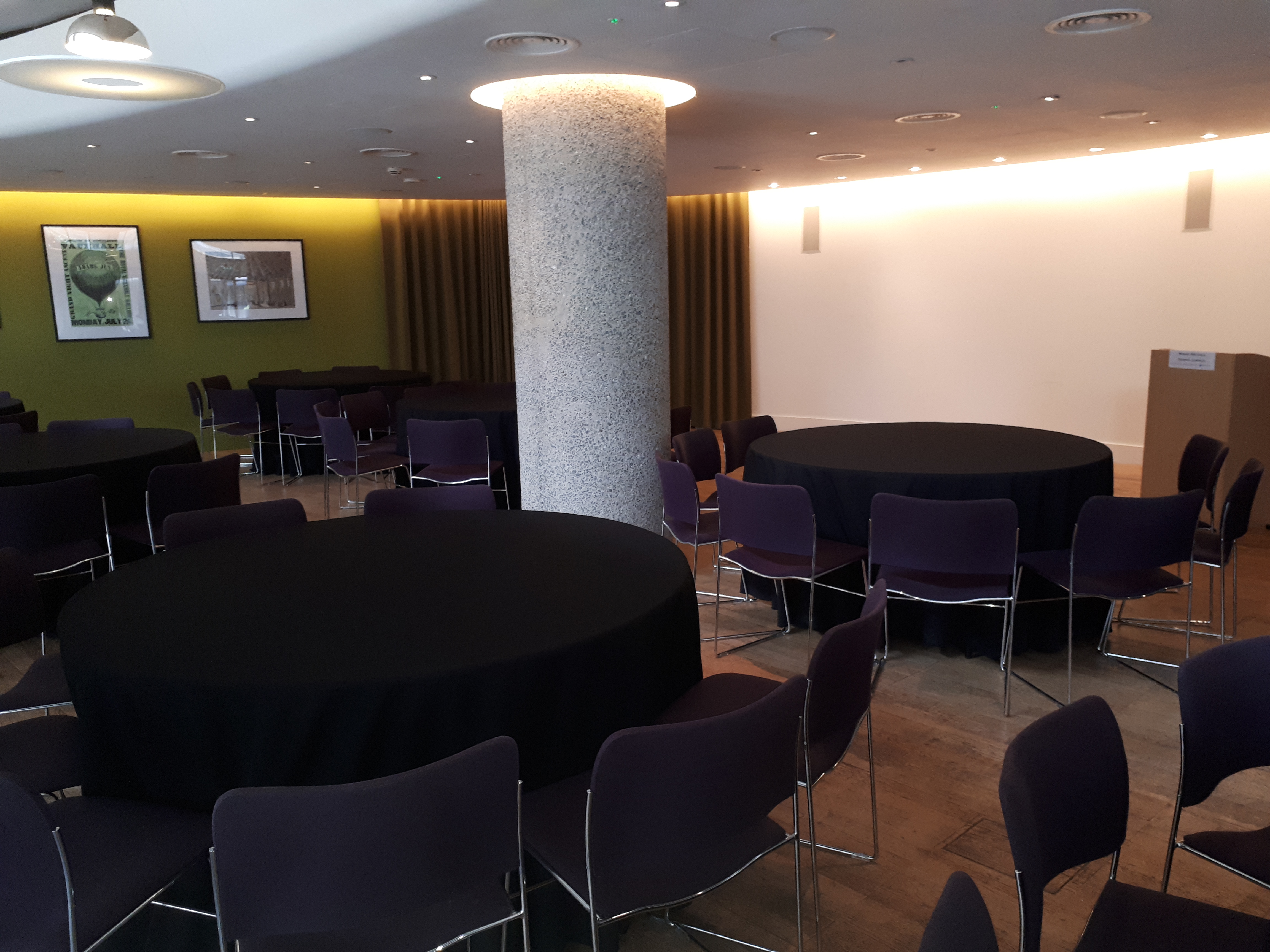 Terrace Gallery meeting space with round tables and purple chairs, ideal for events.