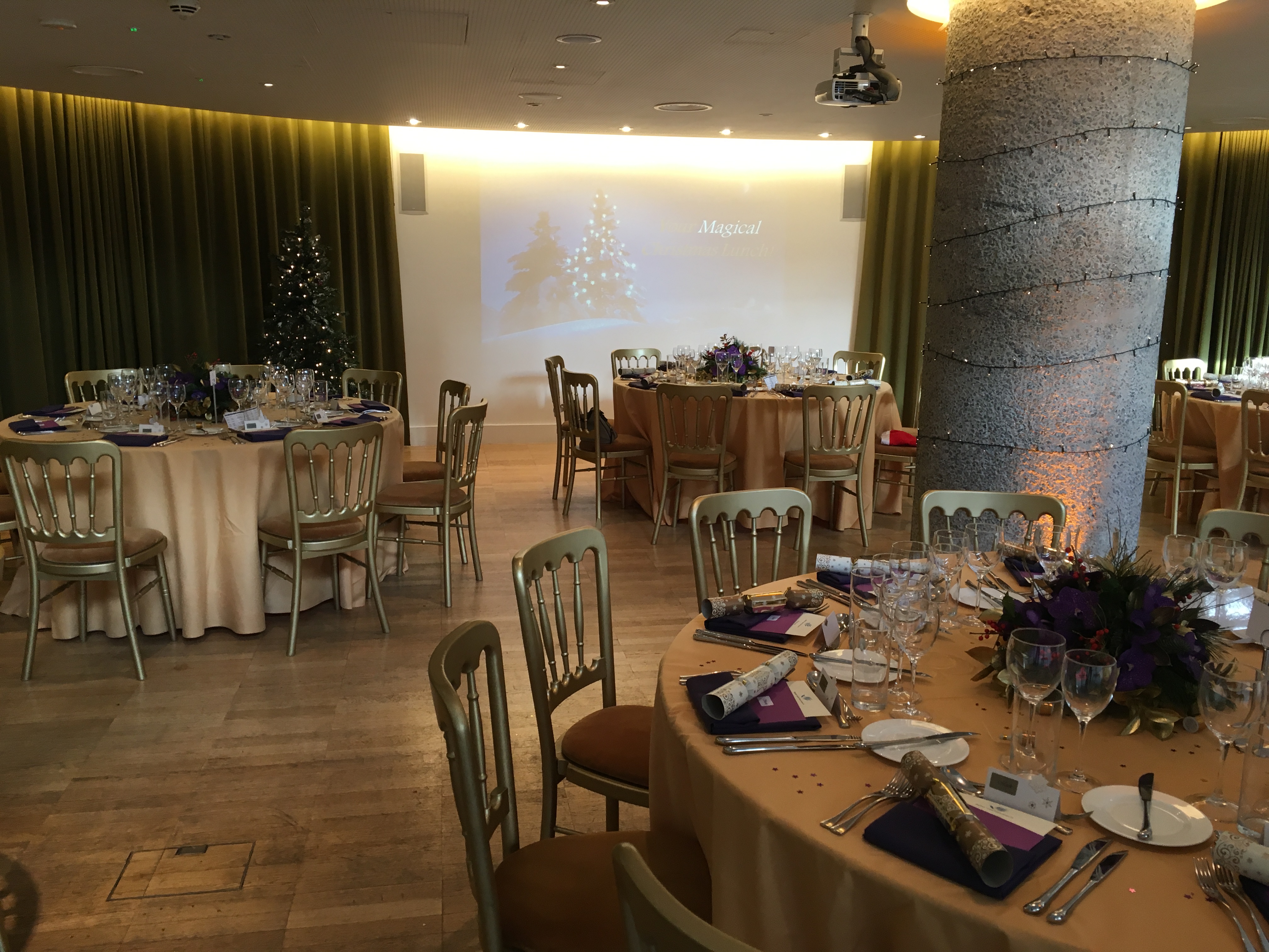 Elegant Terrace Gallery event space with round tables, perfect for corporate gatherings or holiday parties.