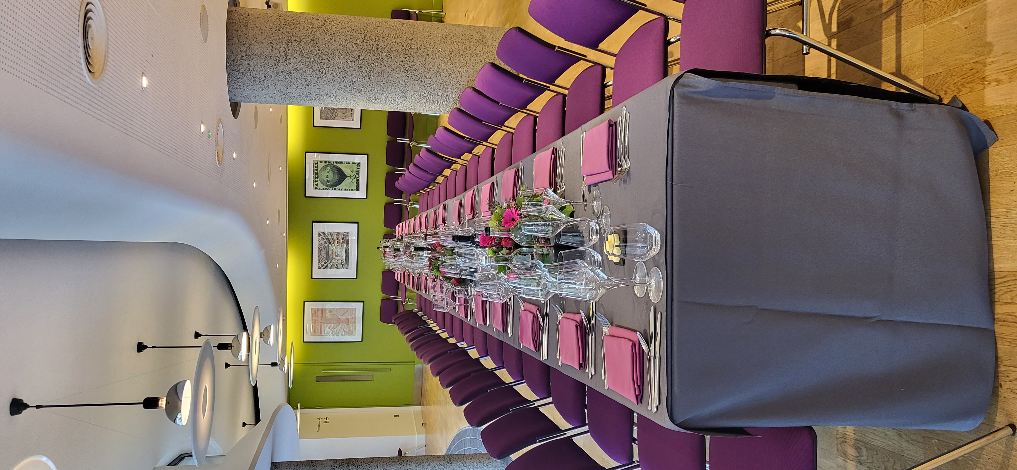 Elegant dining setup with purple chairs at Terrace Gallery, ideal for corporate events.