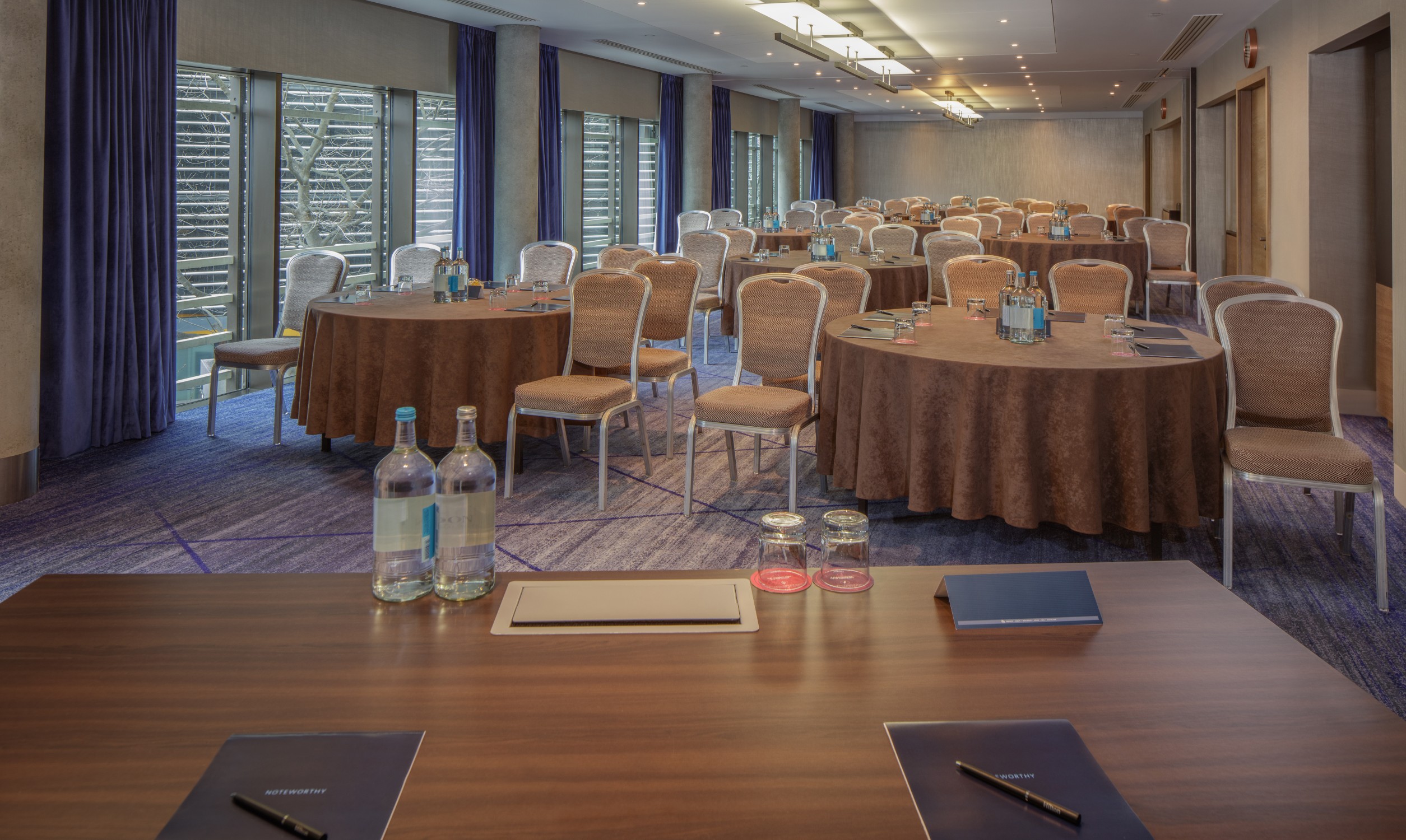 Meeting Room 2/3/4 at Hilton London Tower Bridge, elegant round tables for conferences.