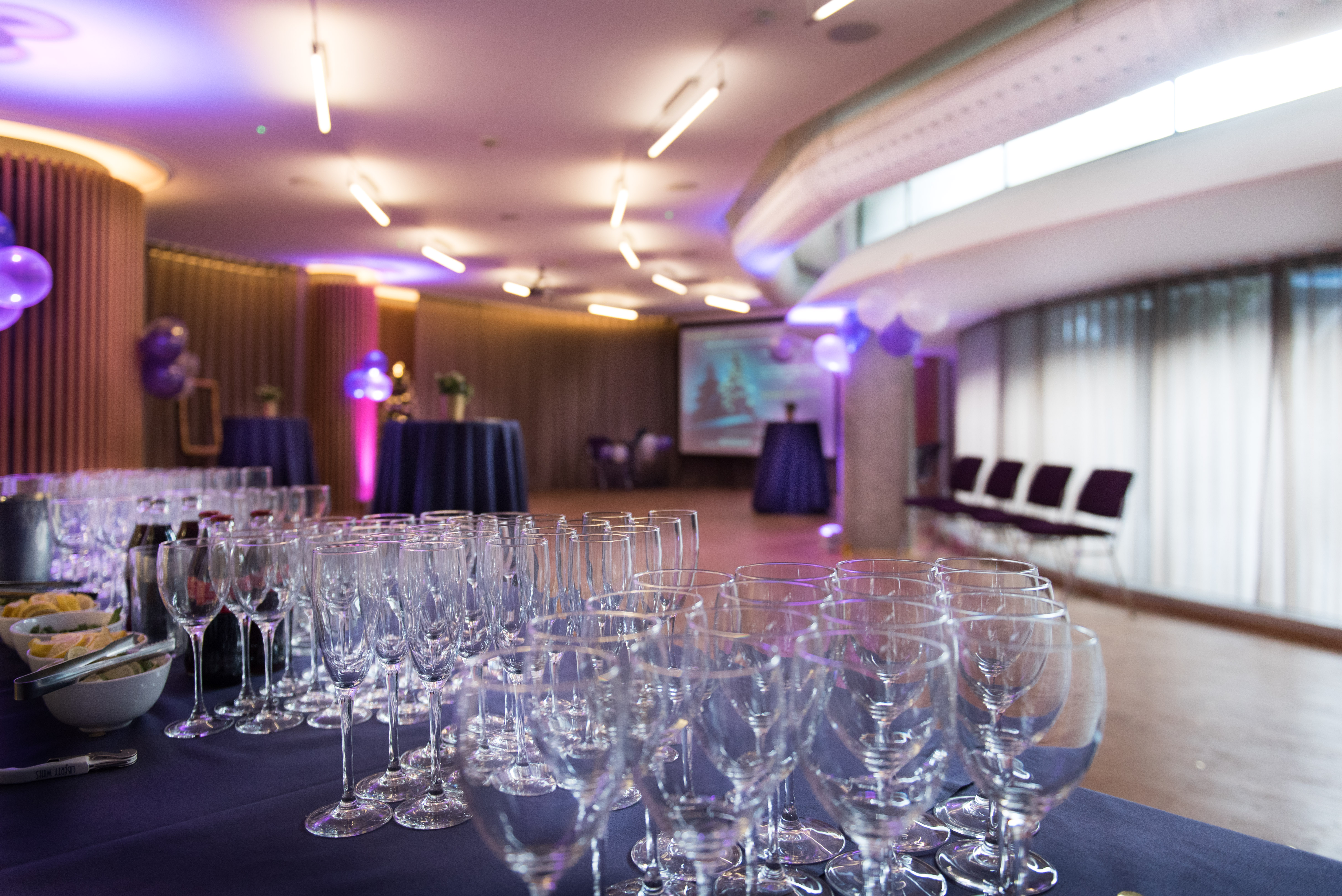 Elegant event space in London Museum with tables, glassware, and festive decor.
