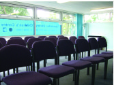 Meeting room with purple chairs in Upminster Library, perfect for workshops and seminars.