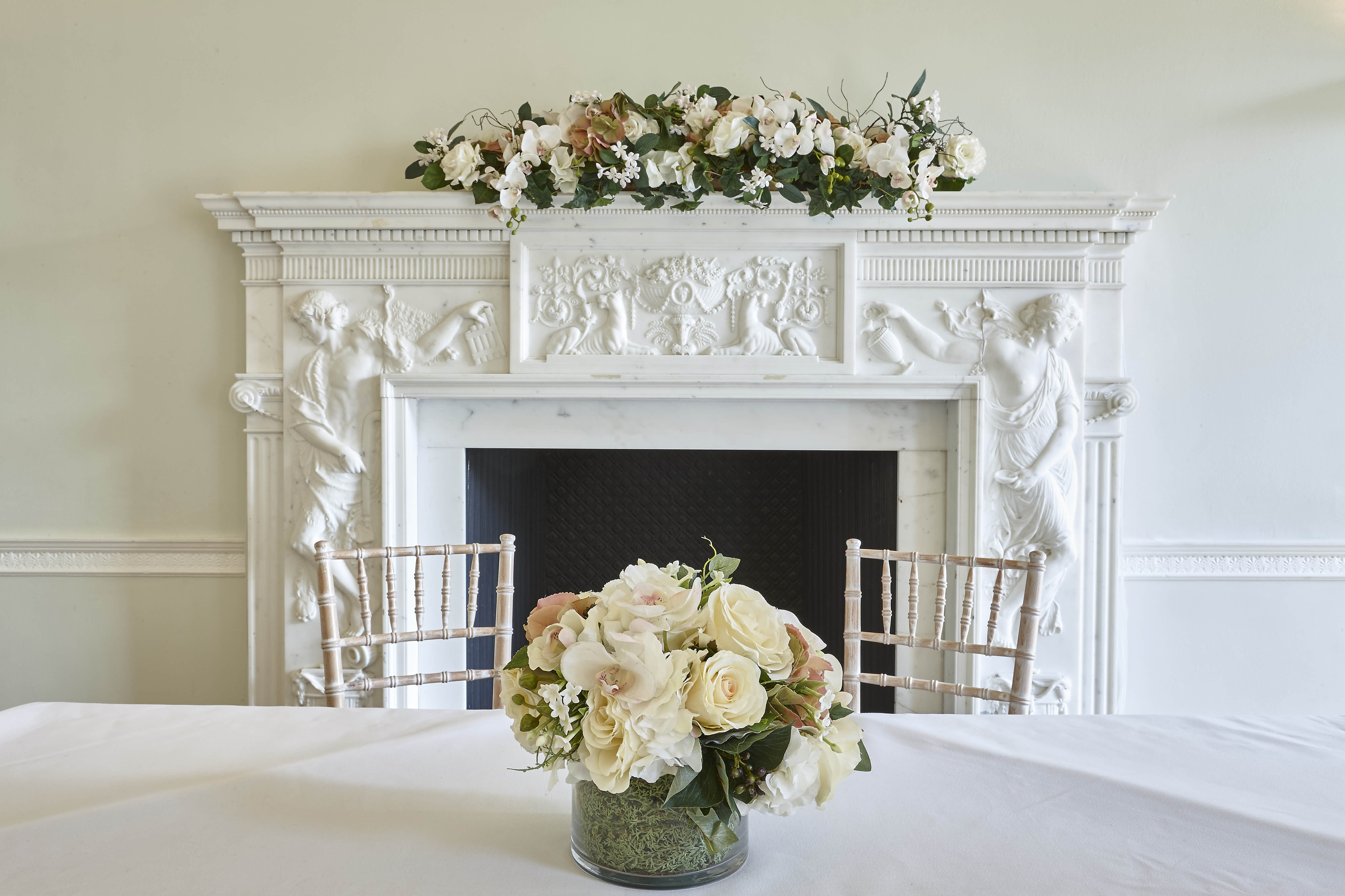 Elegant meeting room with floral fireplace, perfect for upscale events and gatherings.