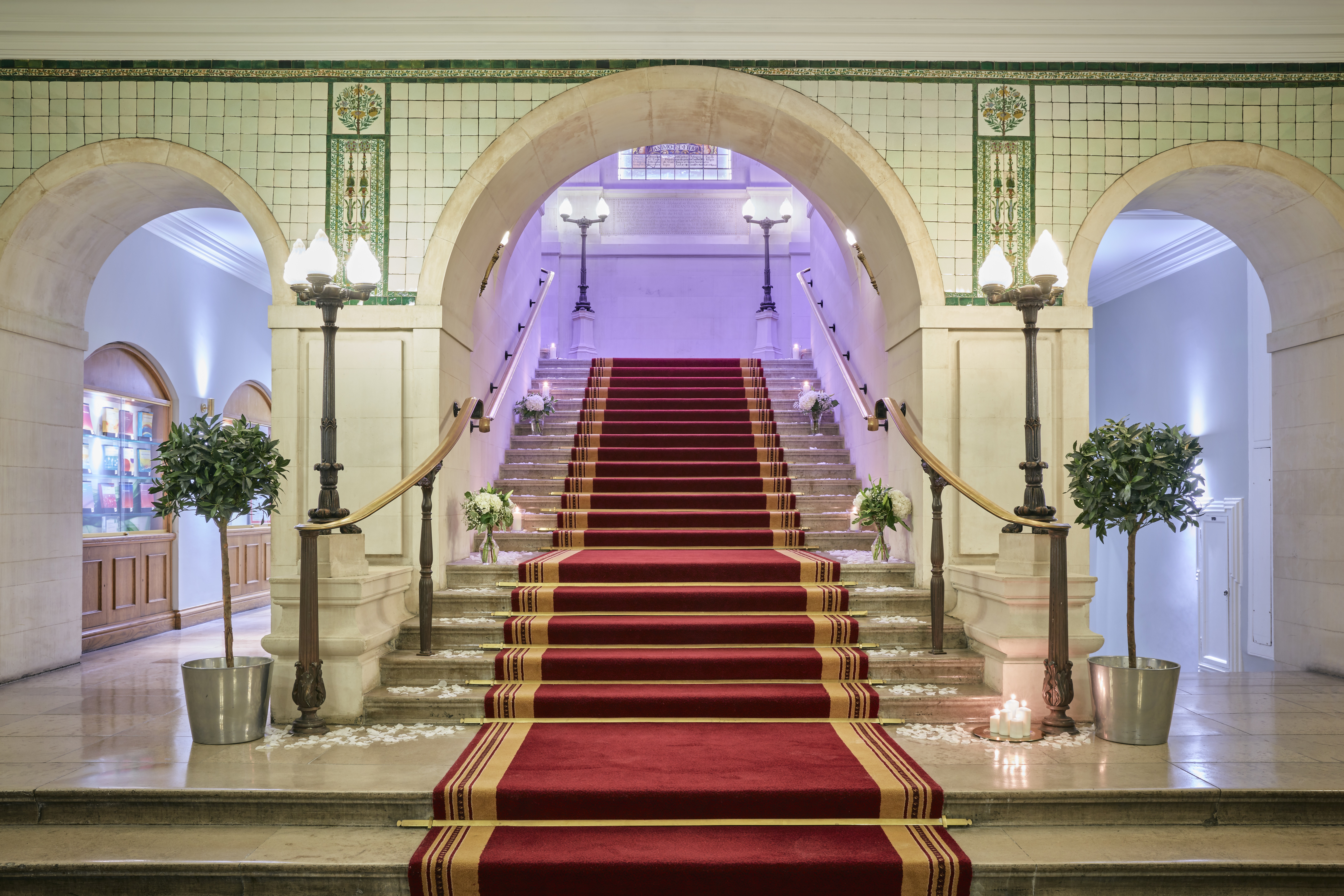 Grand staircase with red carpet in The Common Room, ideal for upscale events and ceremonies.