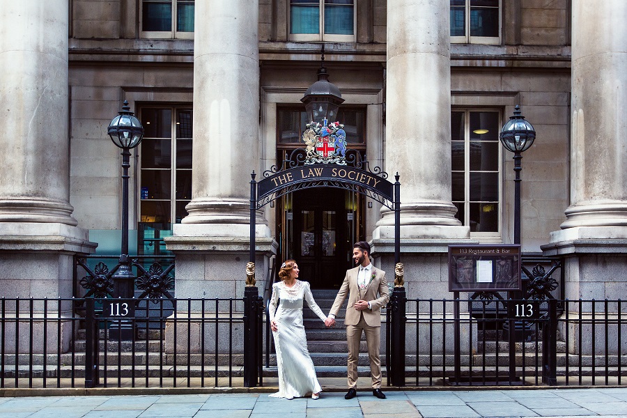 Couple in front of elegant Law Society venue, ideal for upscale weddings and events.