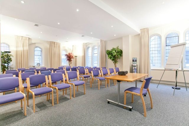 Trevelyan Hall meeting room with purple chairs for professional events and presentations.