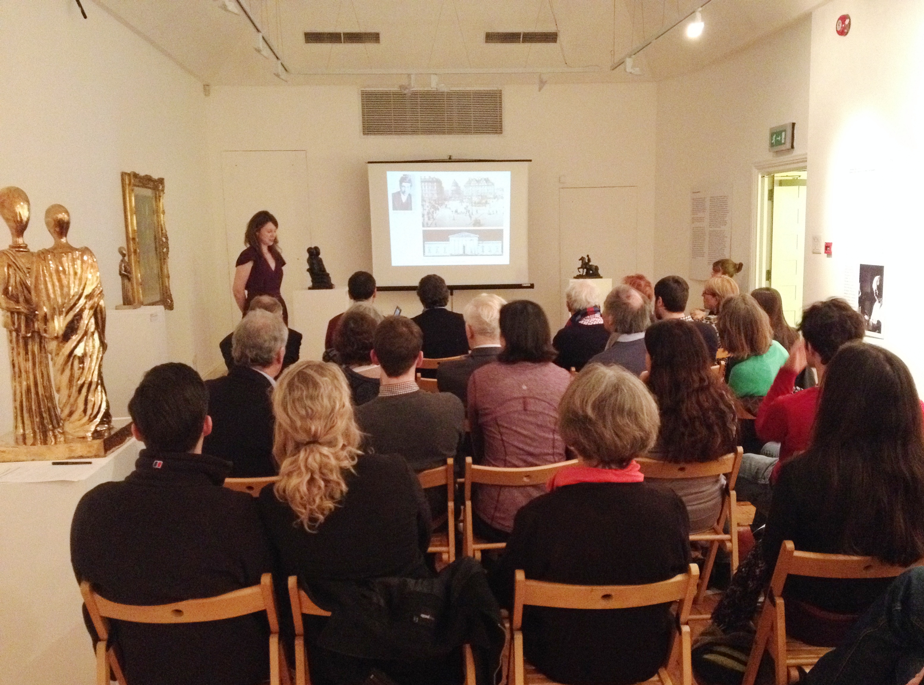 Intimate gallery event at Estorick Collection with engaged audience and art ambiance.