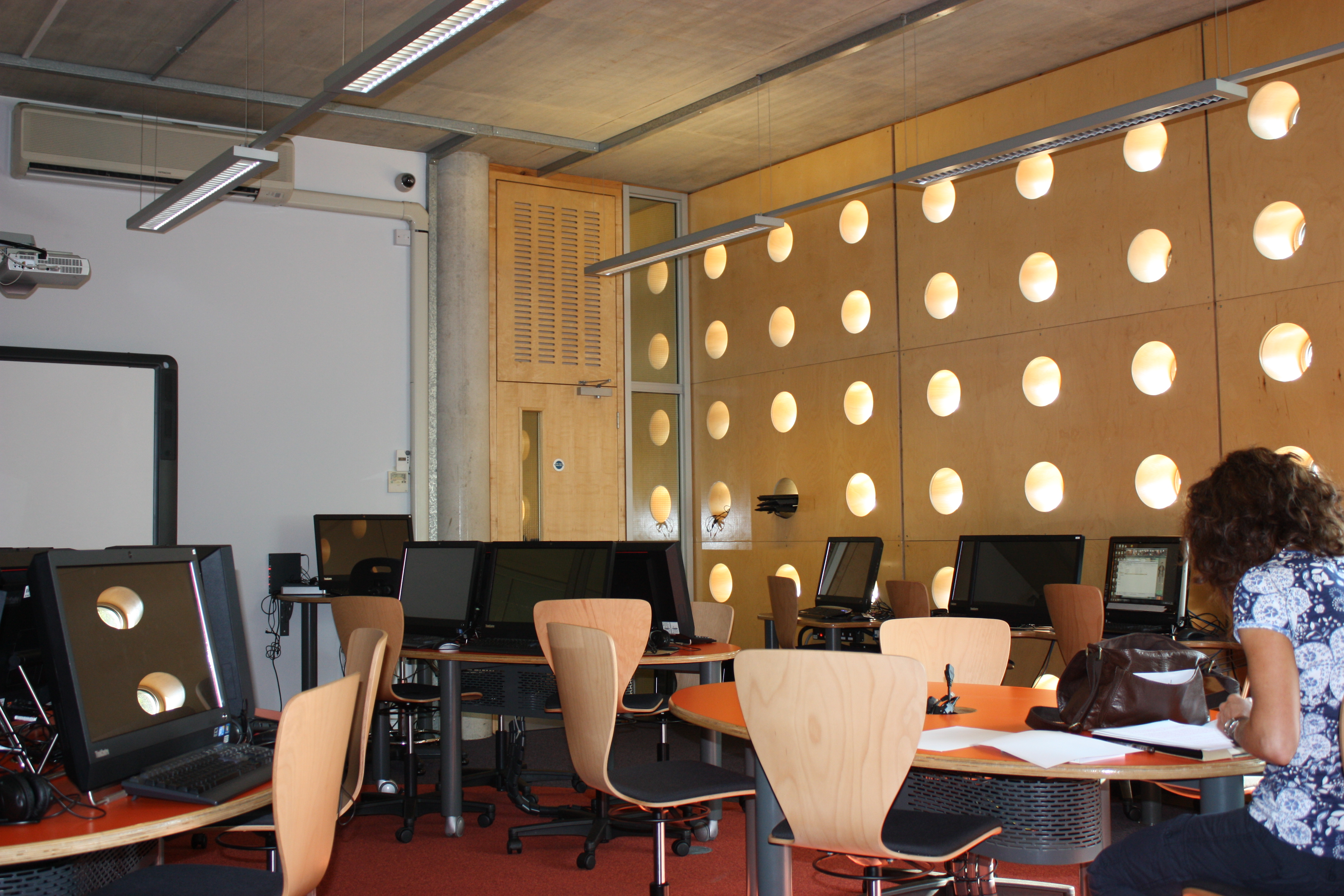 Modern training room with circular windows for workshops and meetings in Camden City Learning Centre.