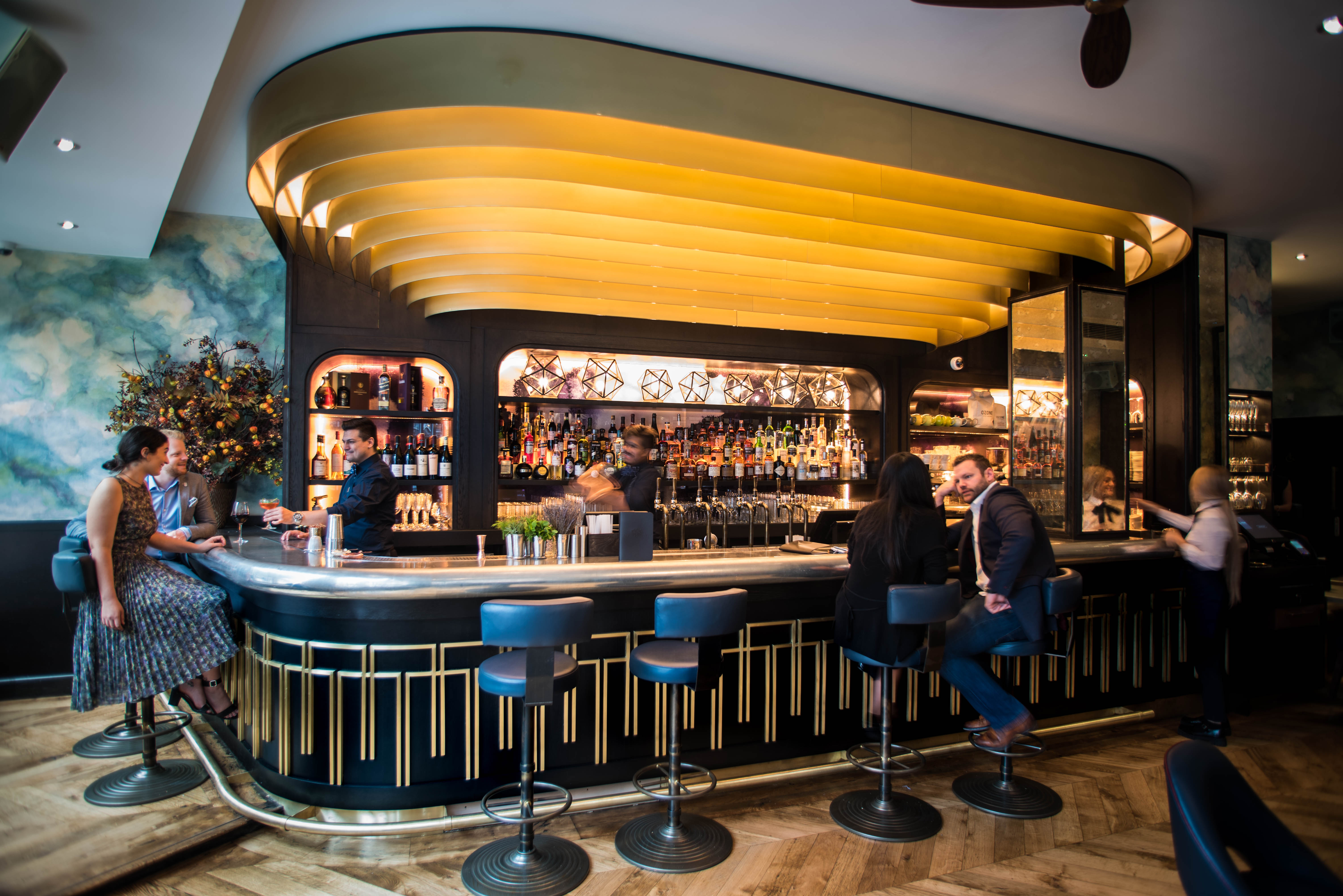 Stylish bar with gold ceiling, ideal for networking events and cocktail receptions.