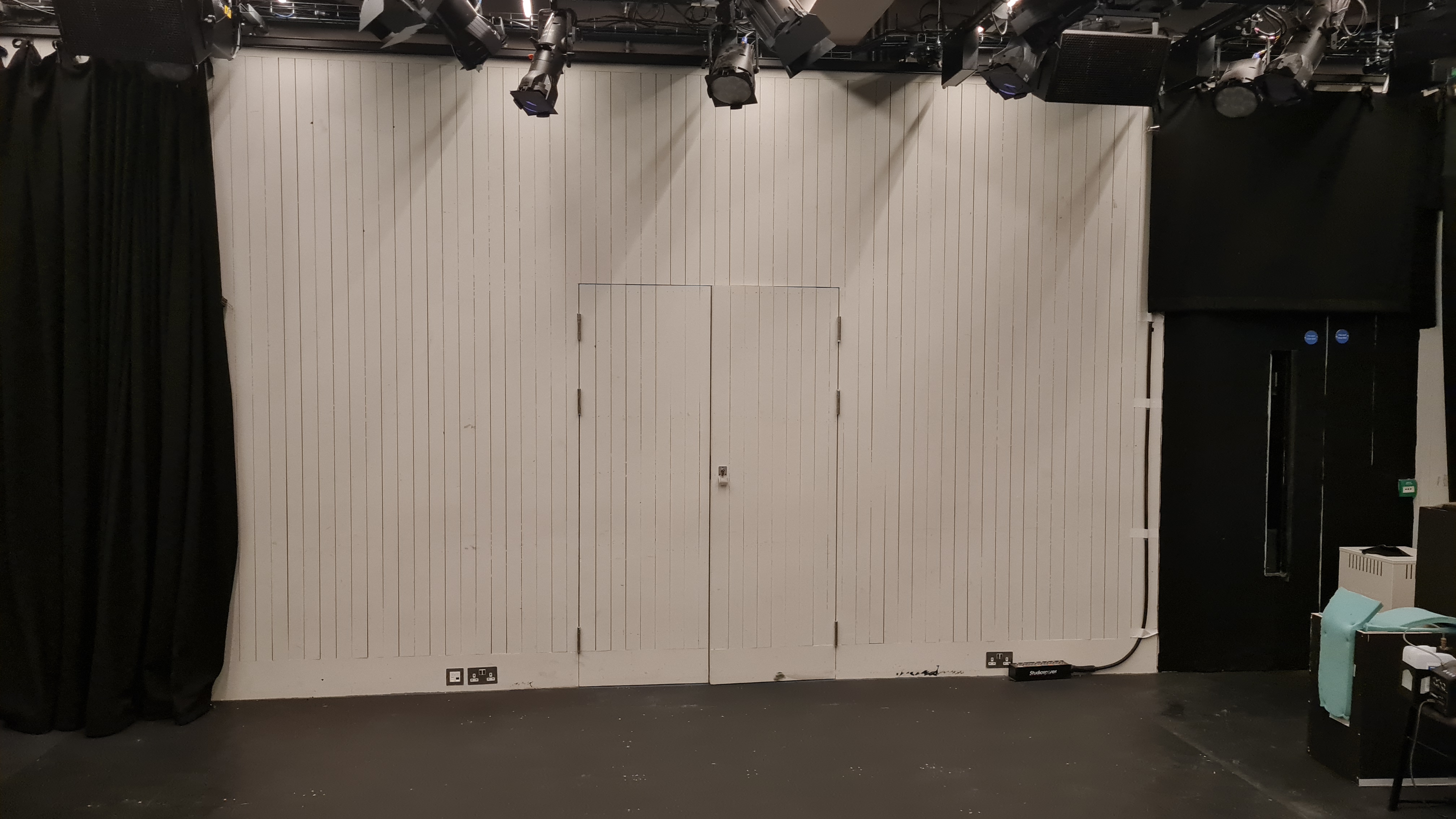 Versatile event space at Bush Theatre with clean white walls for presentations and performances.