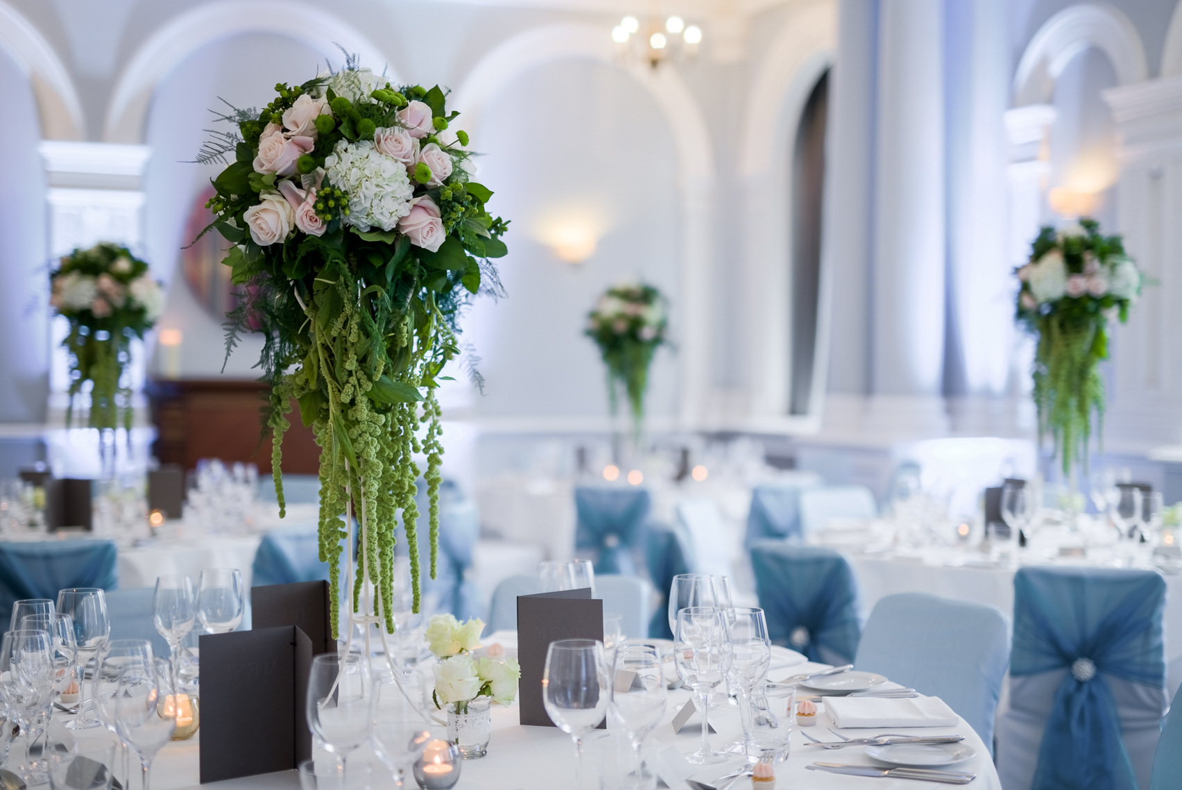 Elegant Fenchurch Suite with tall floral centerpieces for weddings and upscale events.