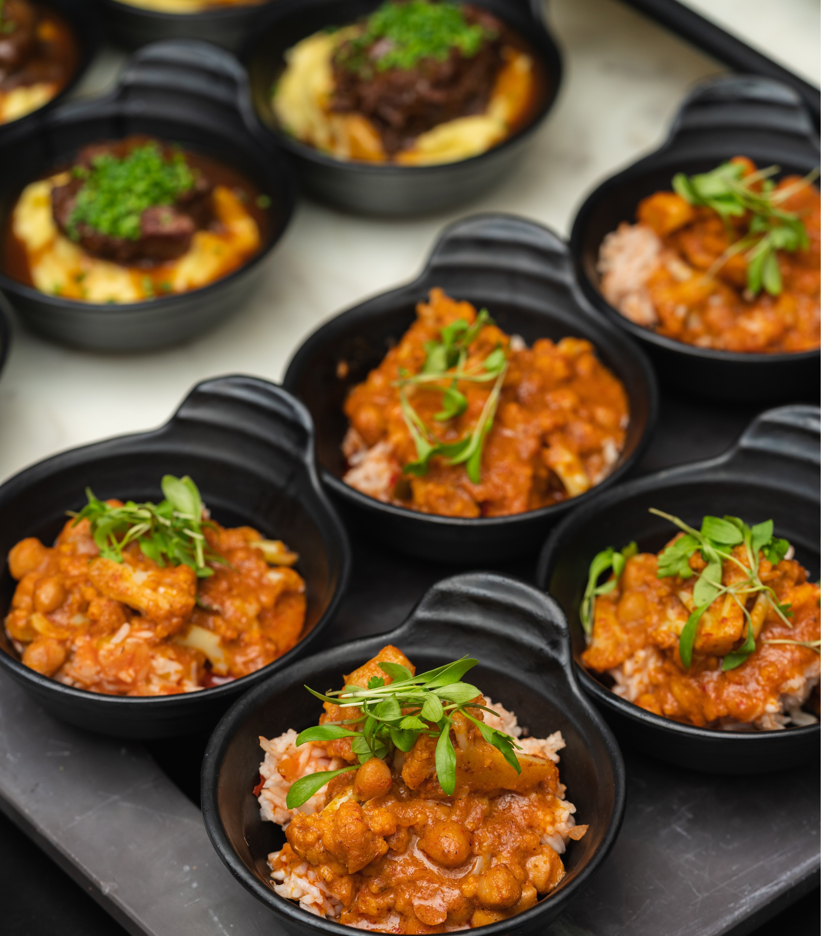 Elegant individual servings in black bowls at Cloud 23, ideal for event catering.