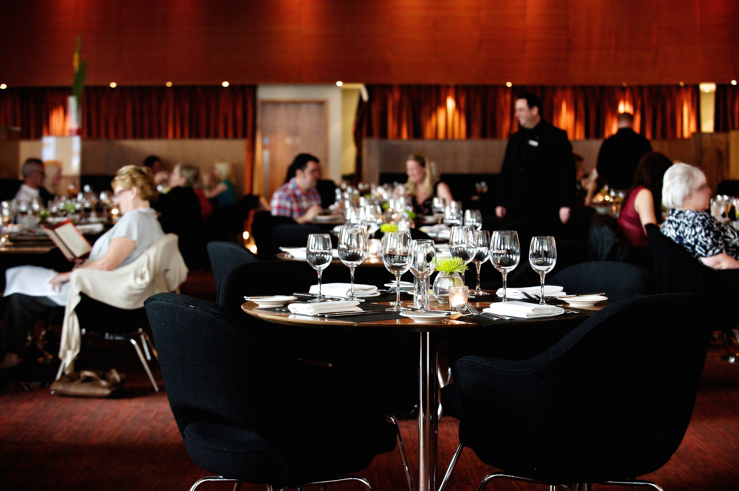 Podium Restaurant & Bar Lounge event setup with elegant tables for networking and celebration.