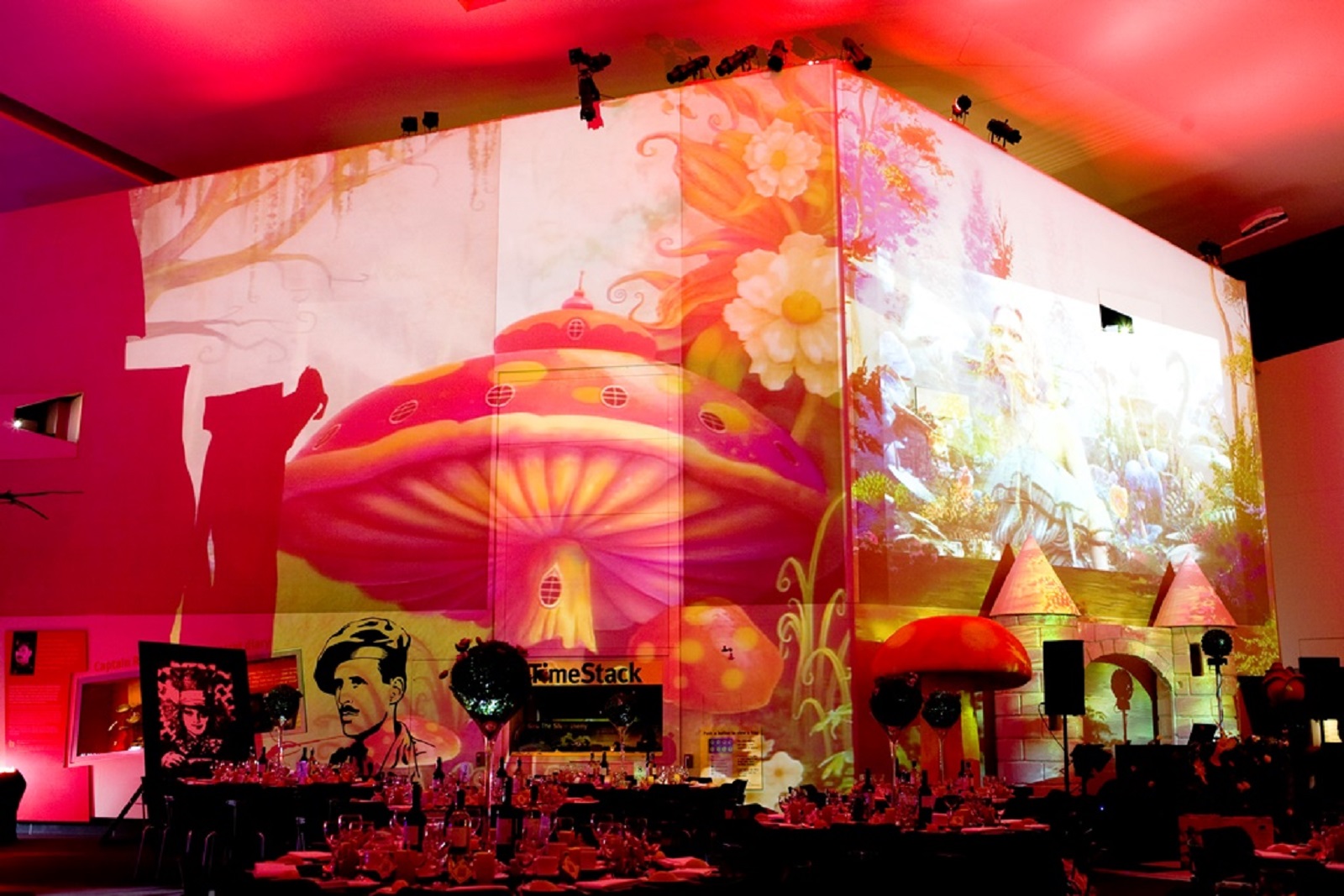 Vibrant event space with whimsical projections at Imperial War Museum North for celebrations.