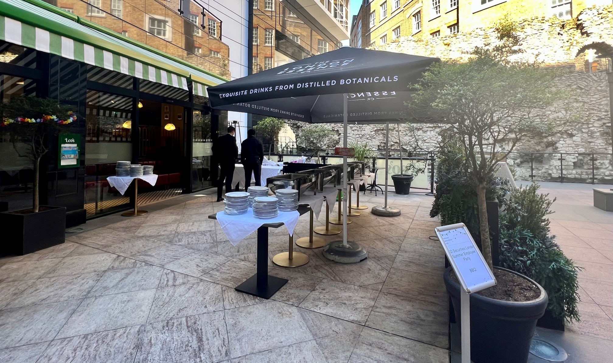 Outdoor event setup at Leonardo Royal Hotel, featuring a black umbrella and elegant buffet.