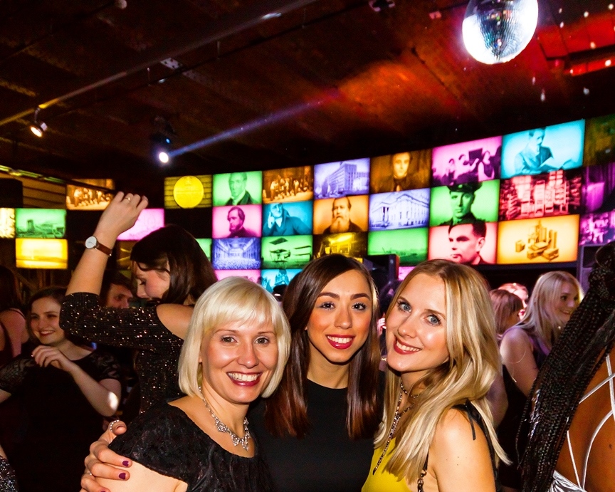 Revolution Manchester Gallery event with colorful screens and diverse attendees.