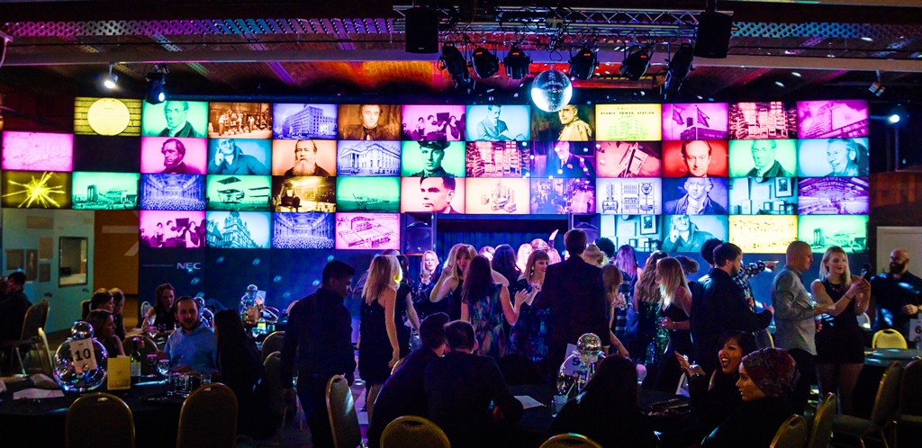 Revolution Manchester Gallery event space with colorful screens, ideal for networking and celebrations.