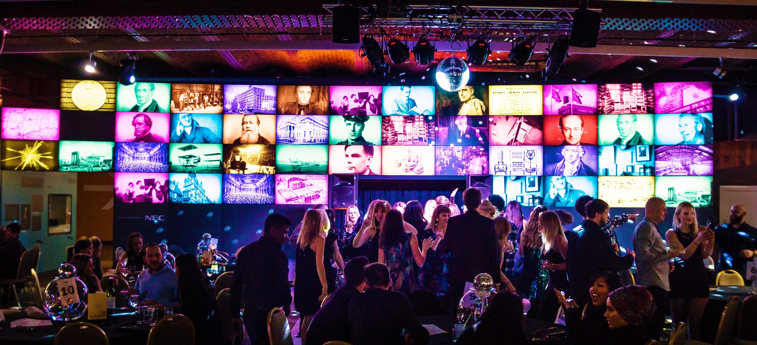 Revolution Manchester Gallery event space with colorful screens and dynamic lighting.