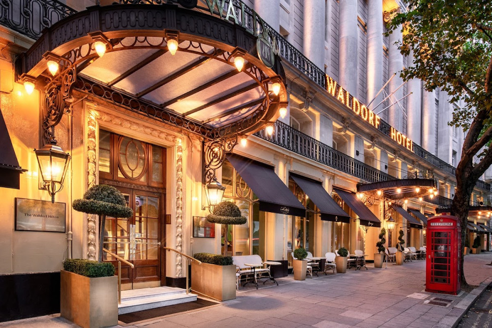 Elegant entrance of Palm Court, Waldorf Hilton, ideal for corporate events and social gatherings.
