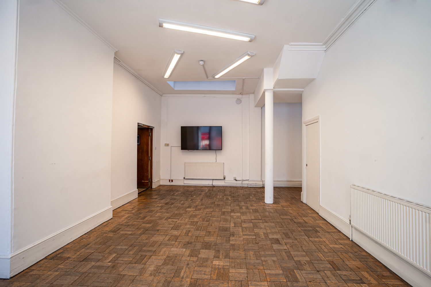 Versatile Bertrand Russell Room with natural light, ideal for workshops and meetings.