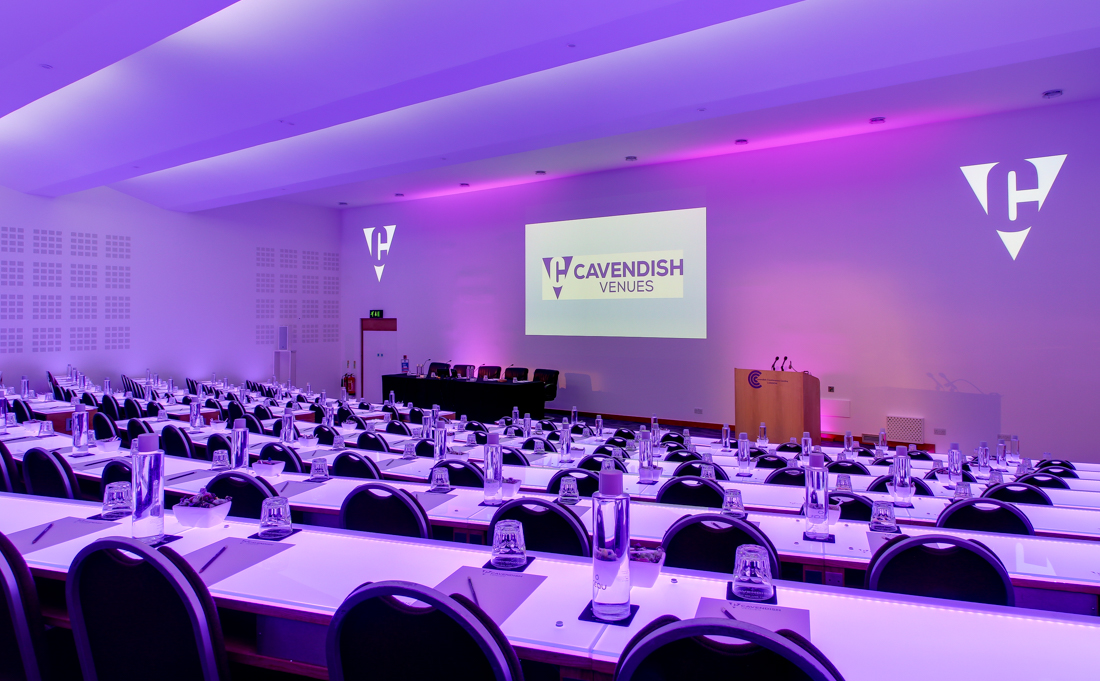 Cavendish Conference Centre auditorium setup for a professional event with purple lighting.
