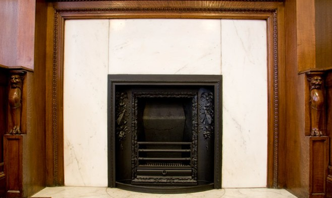 Council Chamber fireplace with marble surround, ideal for upscale events and meetings.