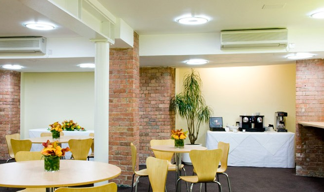 Hallam Café meeting space with round tables, ideal for networking and events.