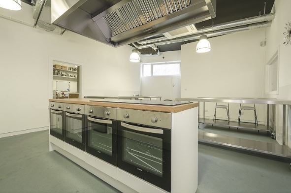 Modern kitchen space at Jenius Social for culinary events and cooking classes.