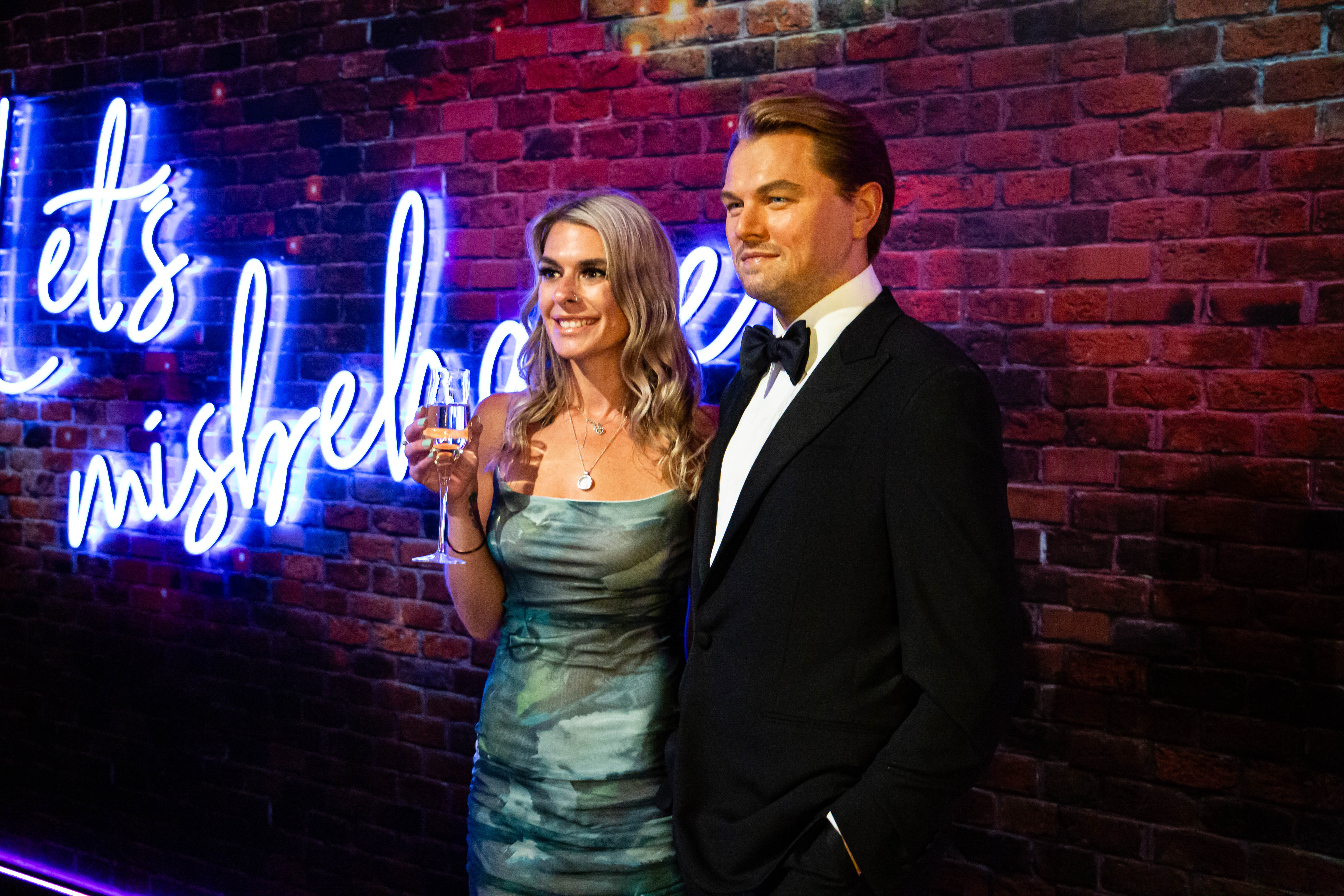 Elegant party at Madame Tussauds with neon backdrop, ideal for networking events.