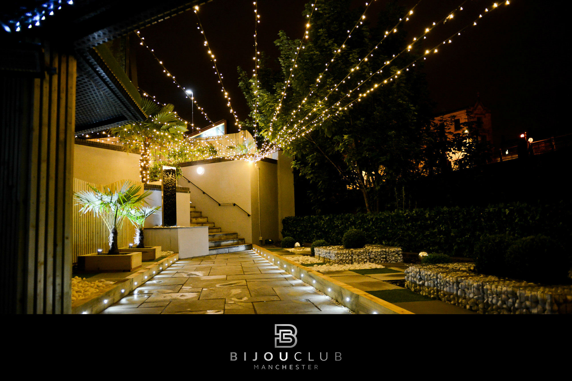 Outdoor venue at Bijou Club, lit with string lights, perfect for weddings and events.