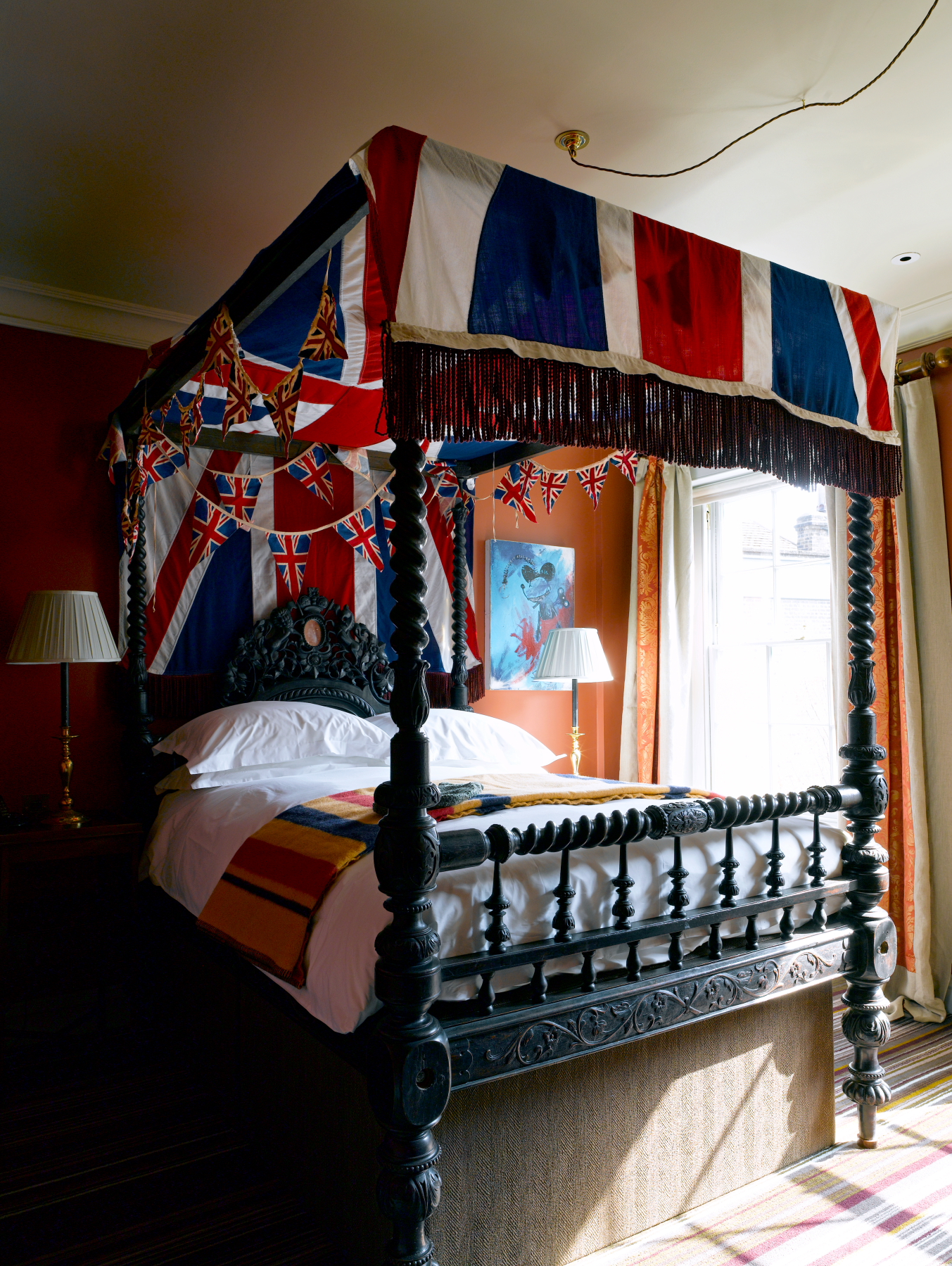 The Zetter Clerkenwell's themed bedroom with British flags and elegant four-poster bed.