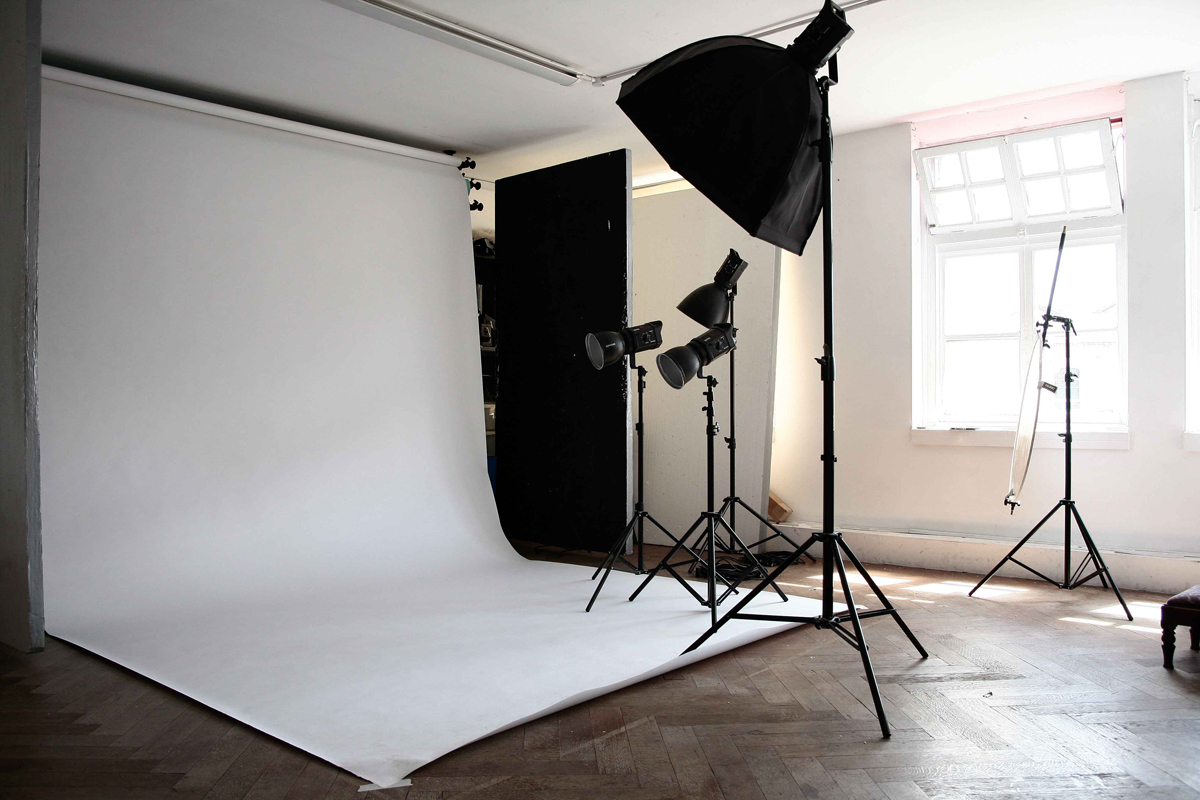 Versatile photo studio with white backdrop for branding events and product launches.