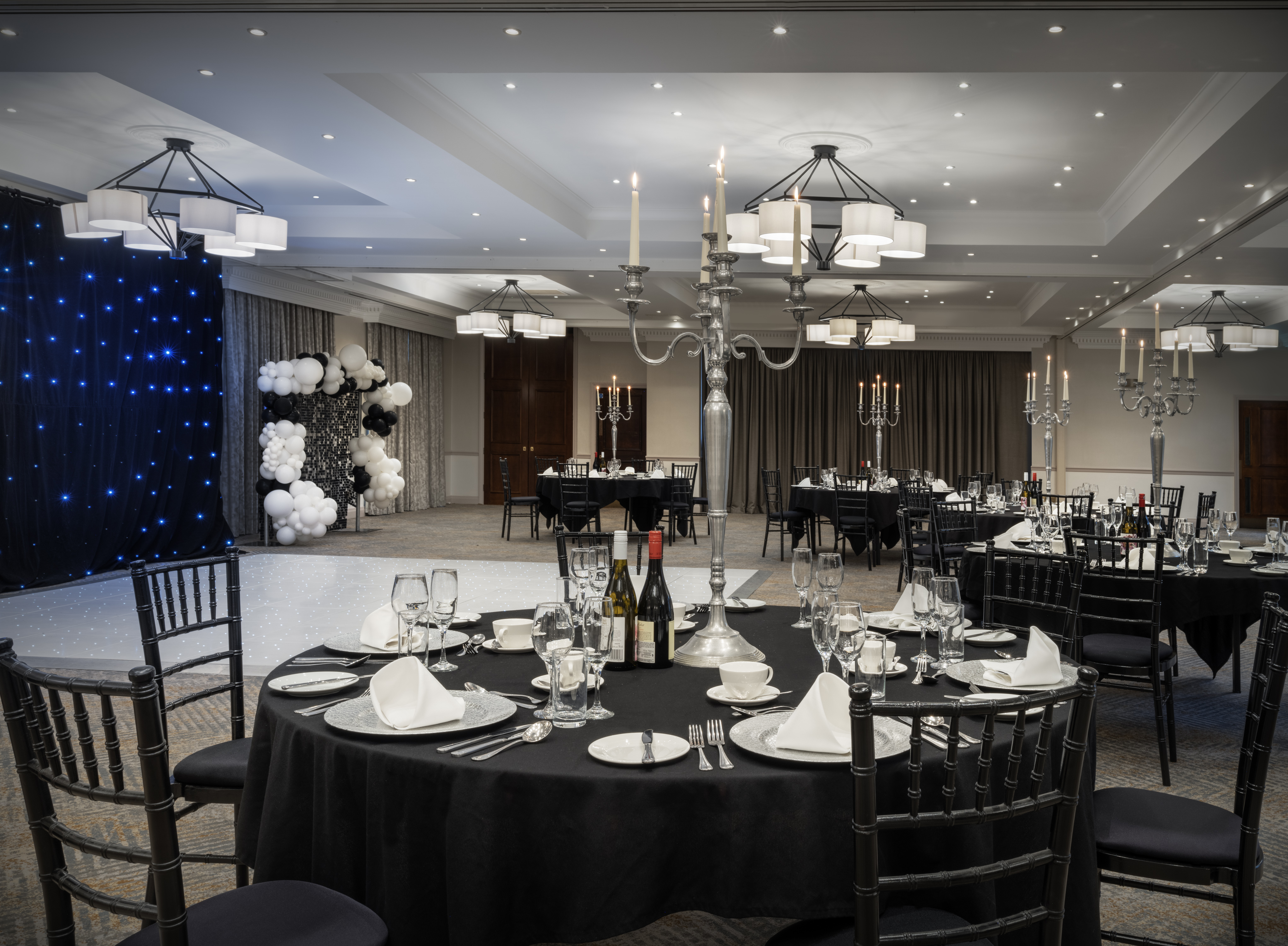 Elegant banquet room with black tablecloths for upscale weddings and corporate events.