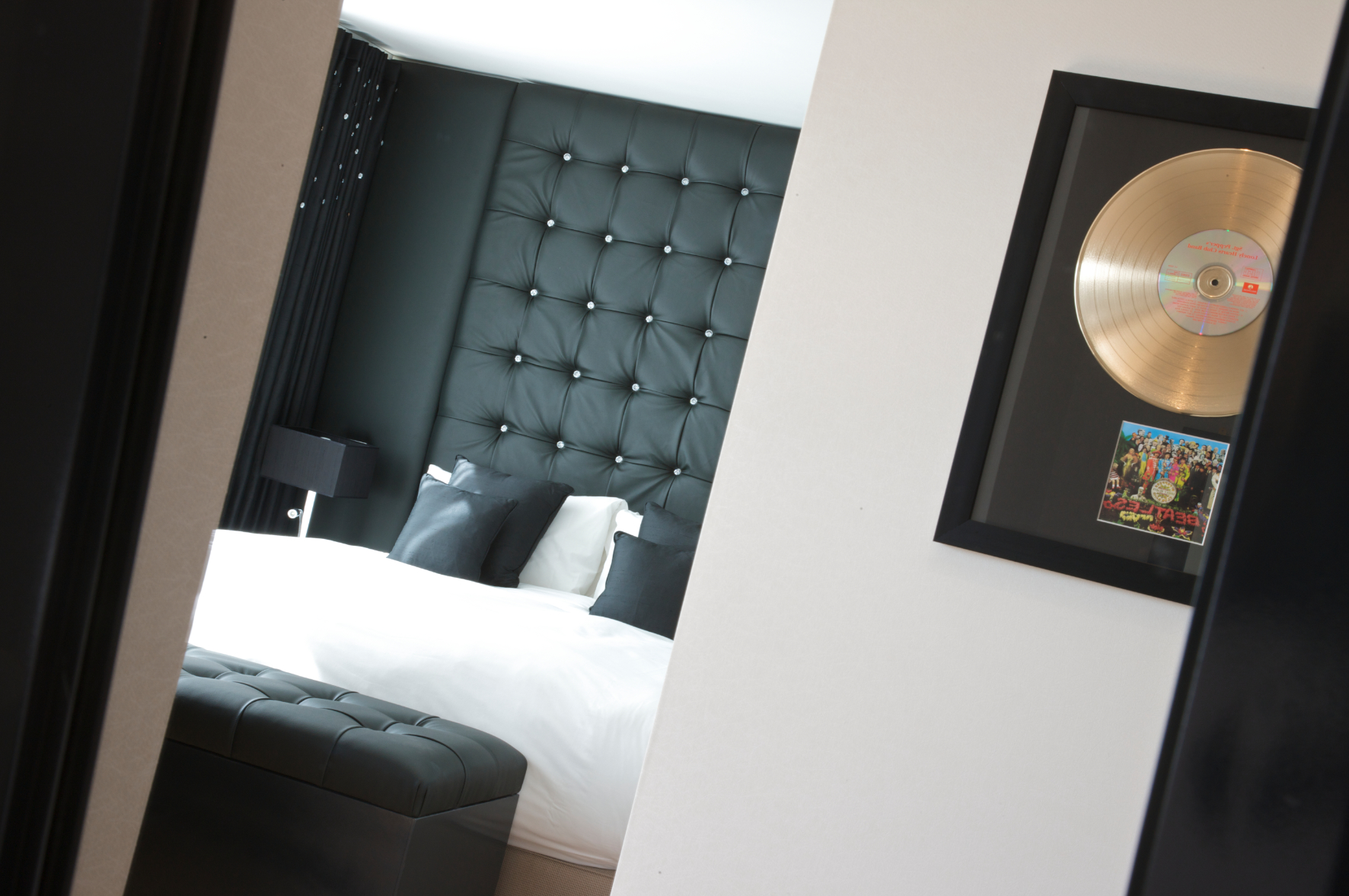 Stylish Lucy Loft Suite with plush bed, ideal for intimate meetings and events.
