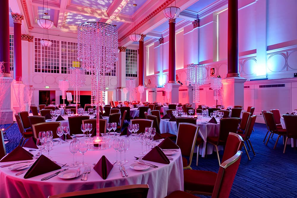 BMA House Great Hall gala dinner with crystal centerpieces and uplighting for corporate events.