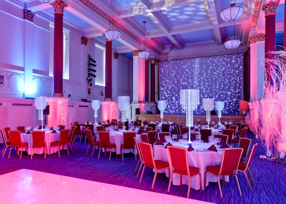Great Hall in BMA House with elegant round tables for galas and formal events.