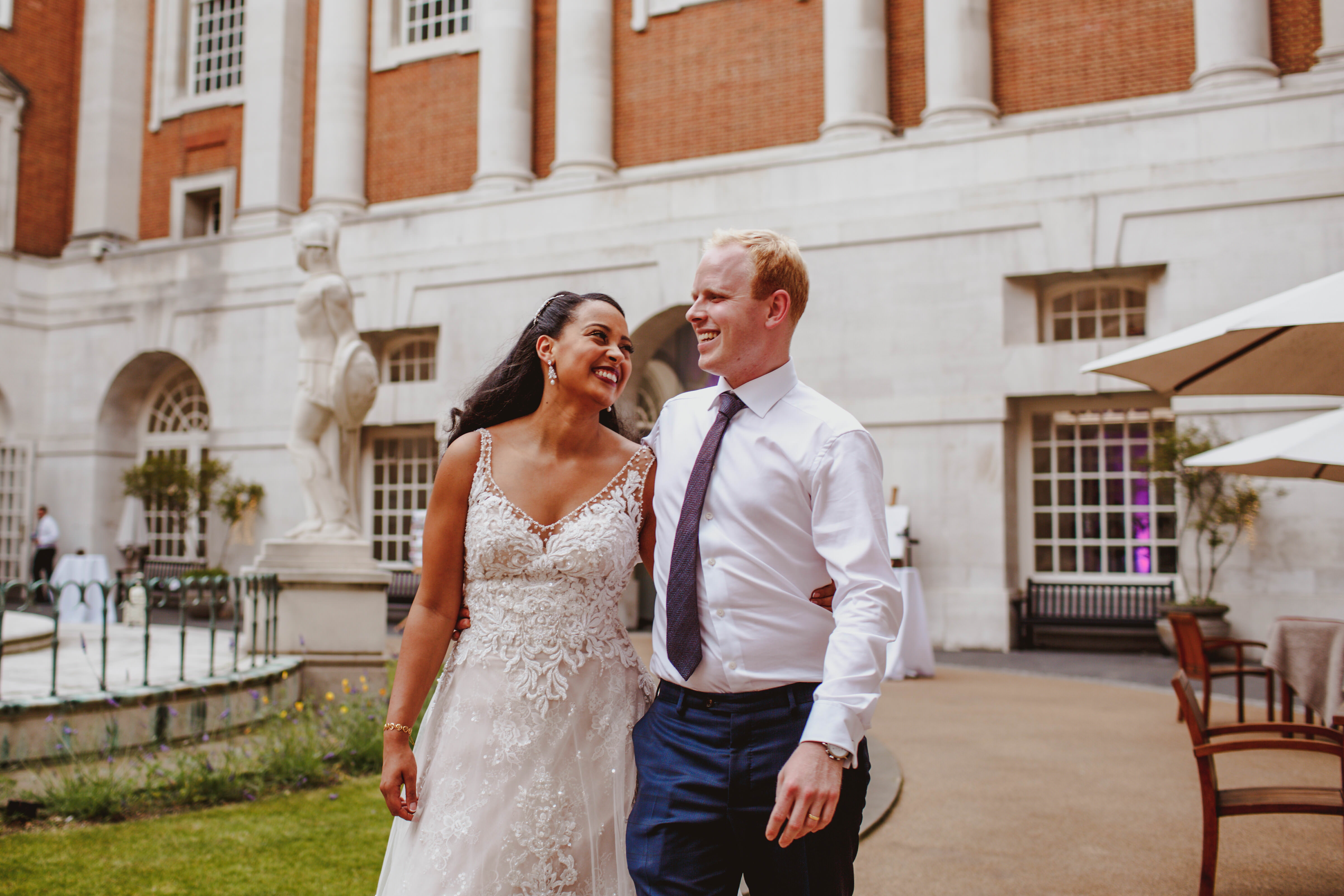 Joyful couple celebrating wedding in elegant outdoor courtyard at BMA House.
