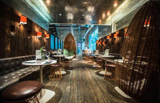 Stylish modern restaurant venue with cozy woven booths for intimate events.