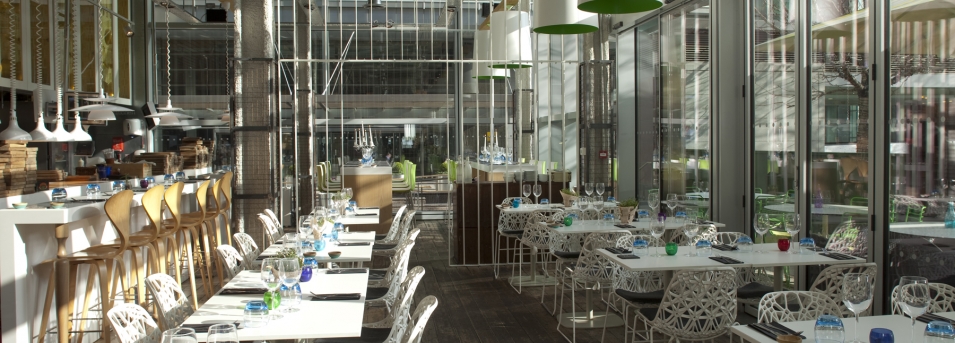 Modern restaurant venue with large windows, ideal for events and gatherings.