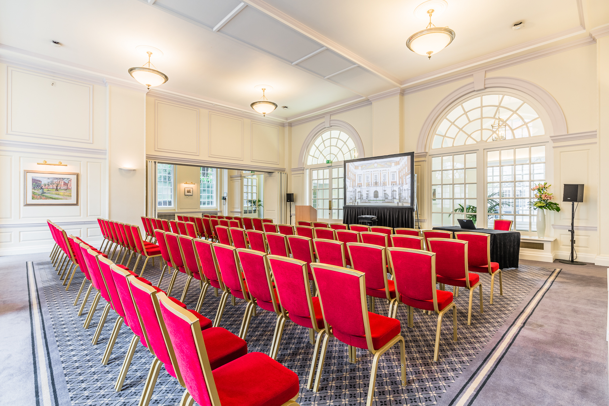 Snow Room in BMA House with red chairs, ideal for conferences and presentations.
