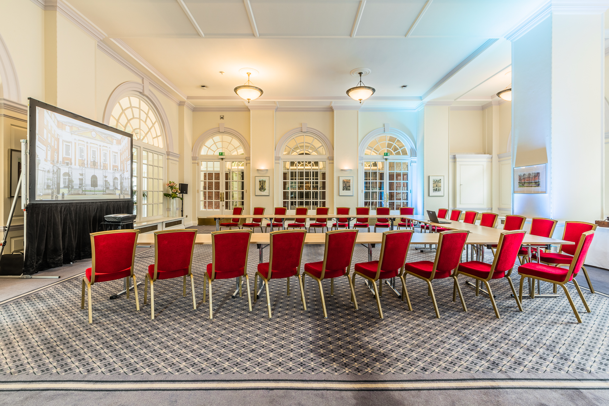 Snow Room in BMA House: modern meeting space with red chairs for workshops and presentations.