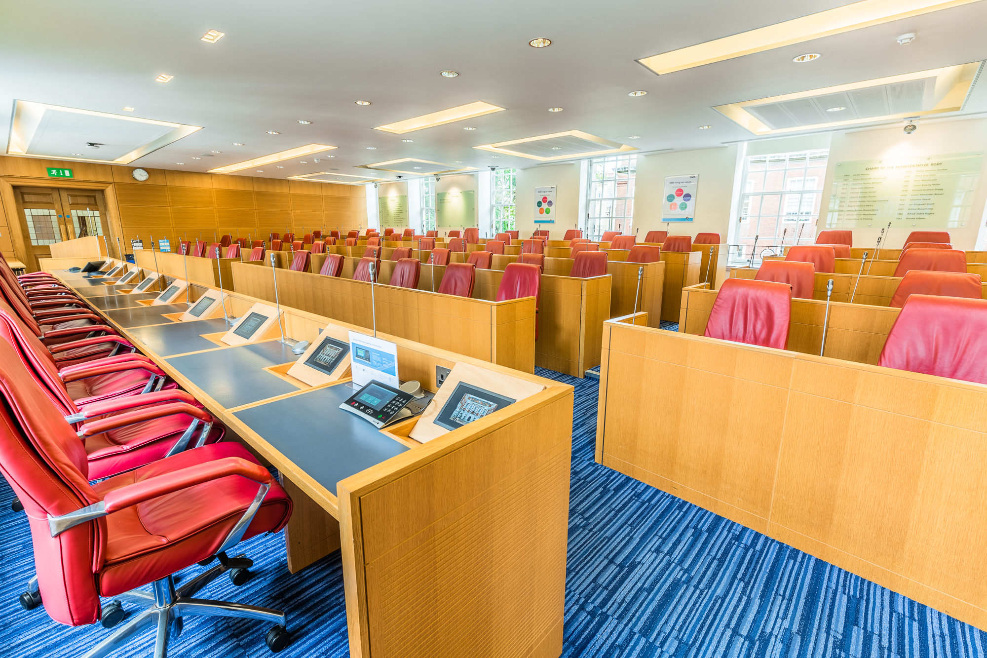 Modern conference room with ergonomic red chairs for meetings and events at BMA House.