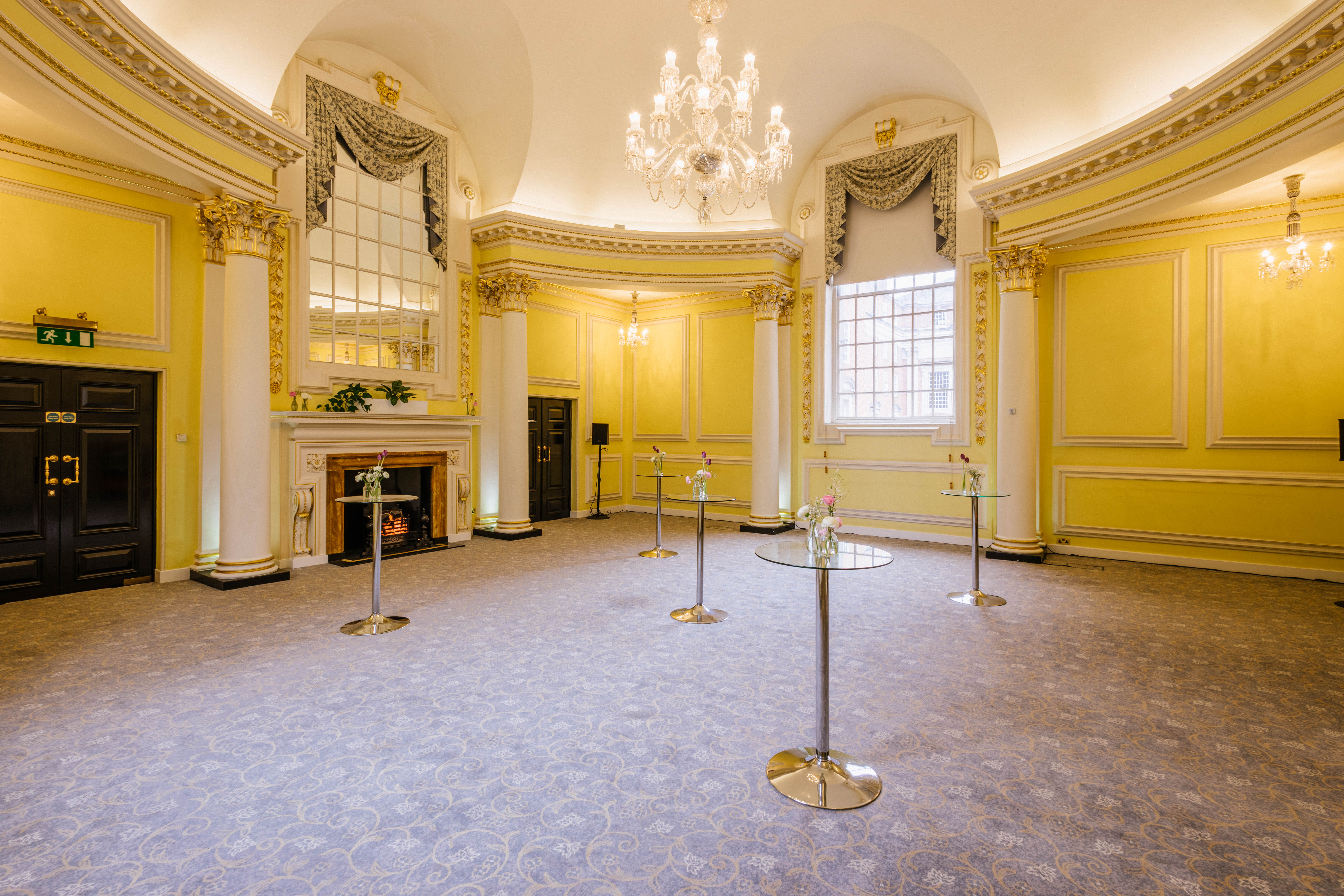 Elegant event space in Prince's Room, BMA House with yellow walls and chandeliers.