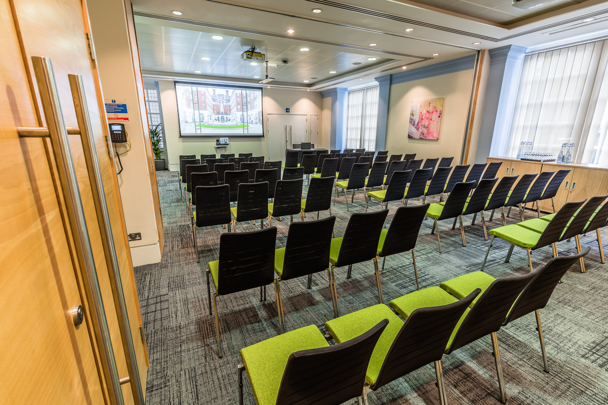 Courtyard Suite at BMA House, modern meeting room with projector for presentations.