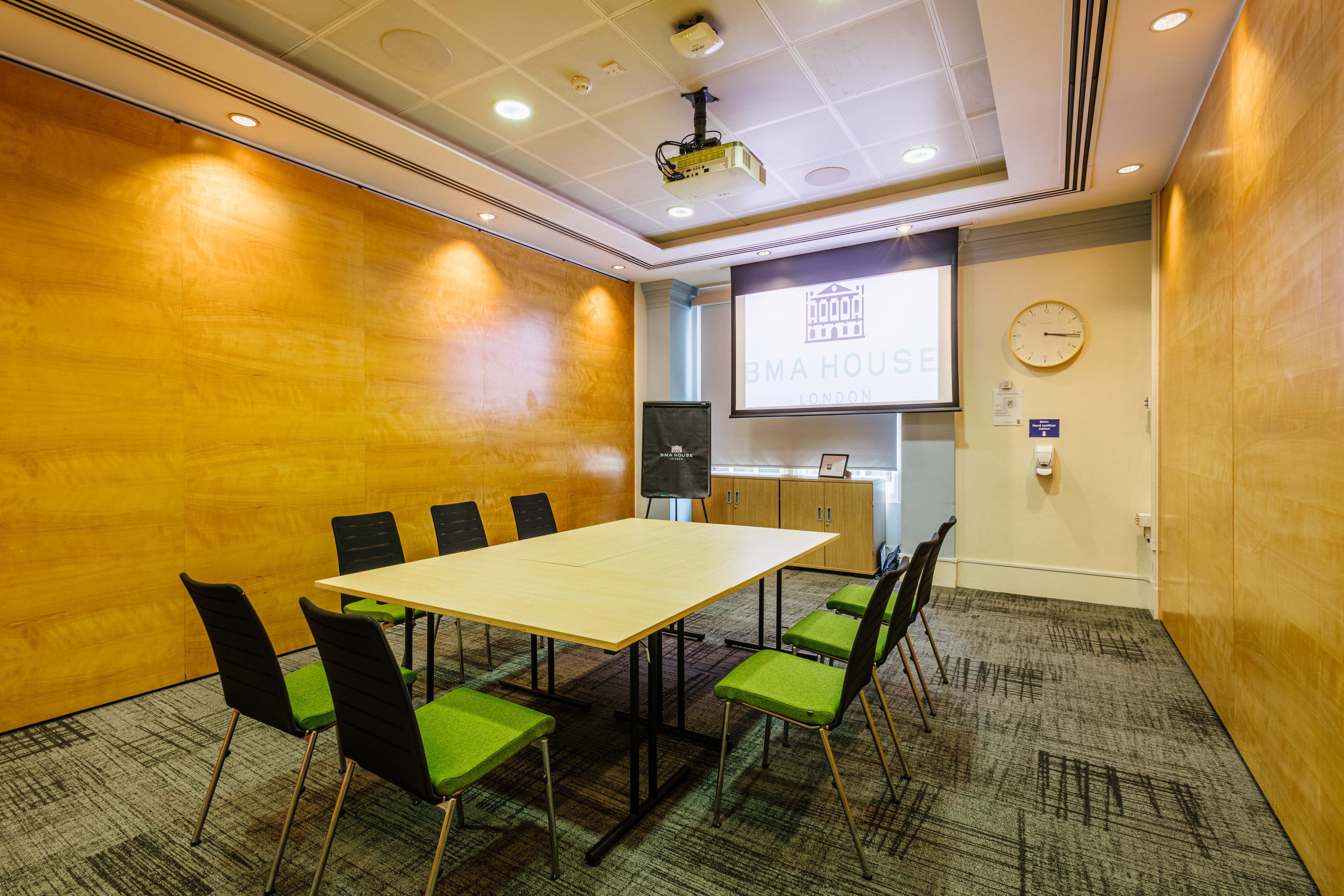 Barnes Room in BMA House: modern meeting space with projector for workshops and presentations.