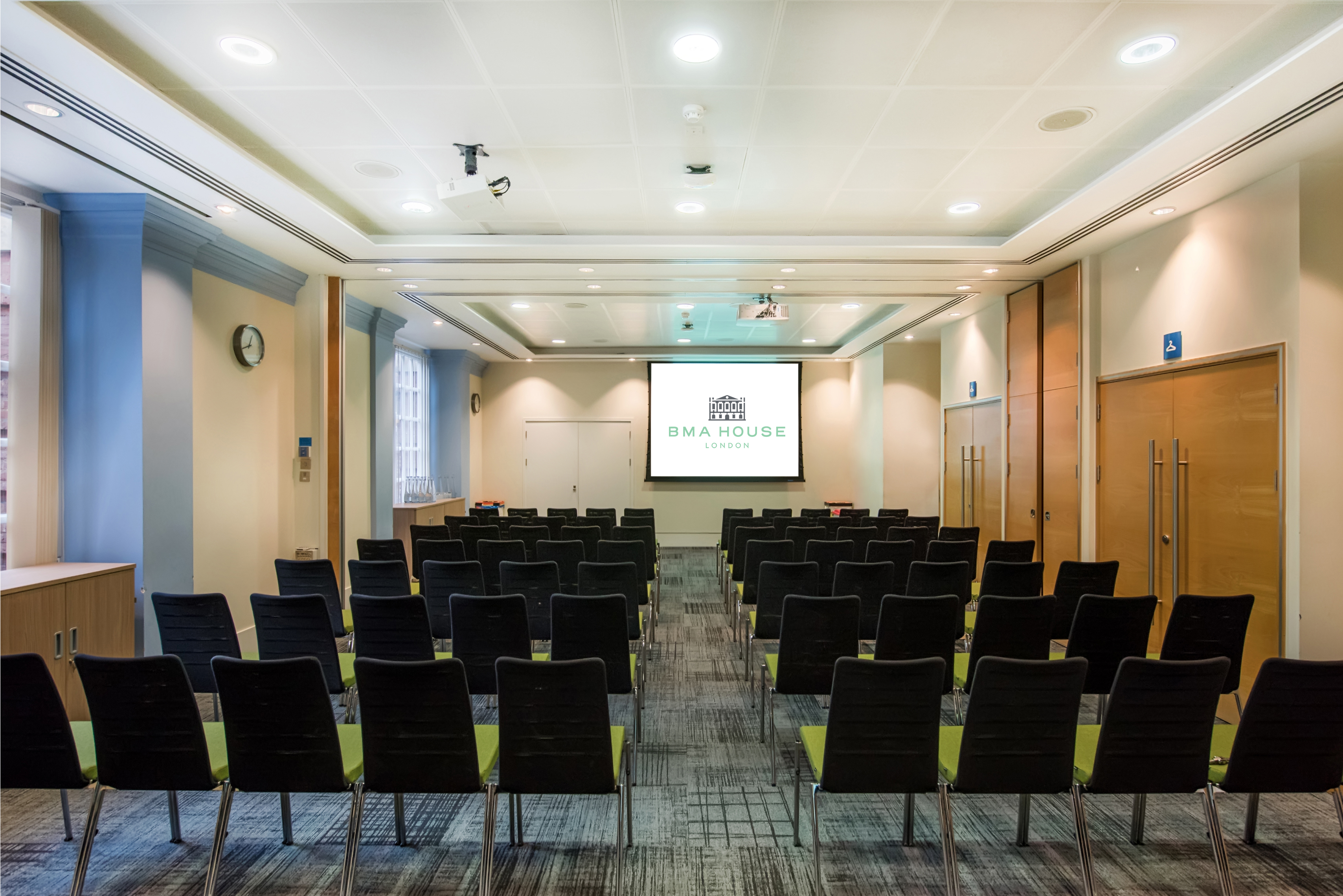 Anderson Barnes Suite meeting room with large screen, ideal for conferences and workshops.