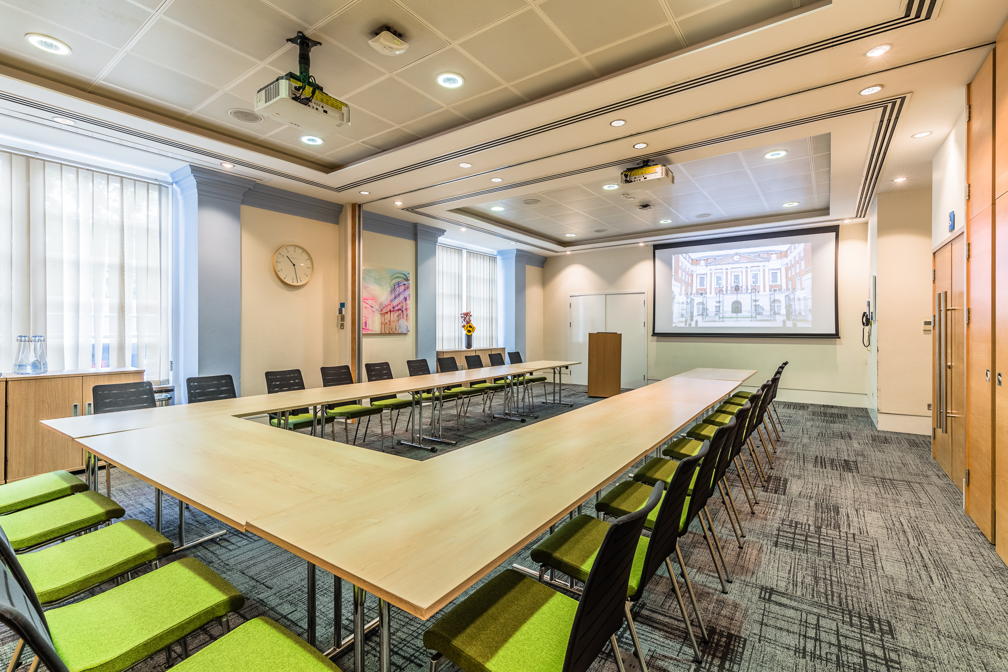 Anderson Barnes Suite meeting room with U-shaped table for presentations and collaboration.