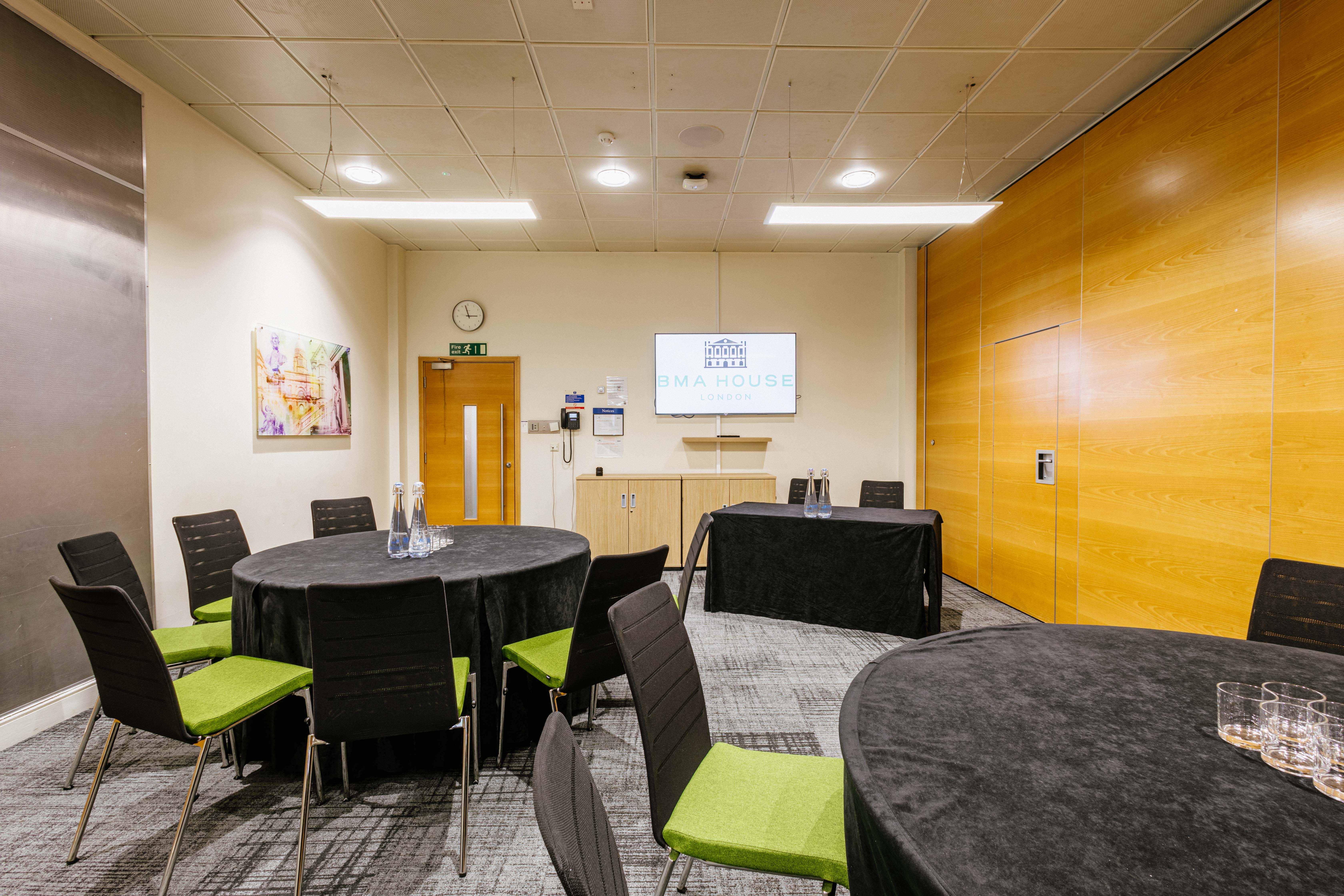 Lister Fleming Suite in BMA House: stylish meeting room with round tables for corporate events.